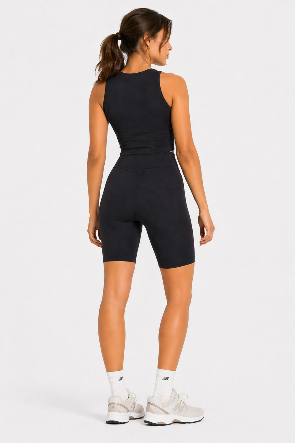 Back view of black fitted cycling shorts on model