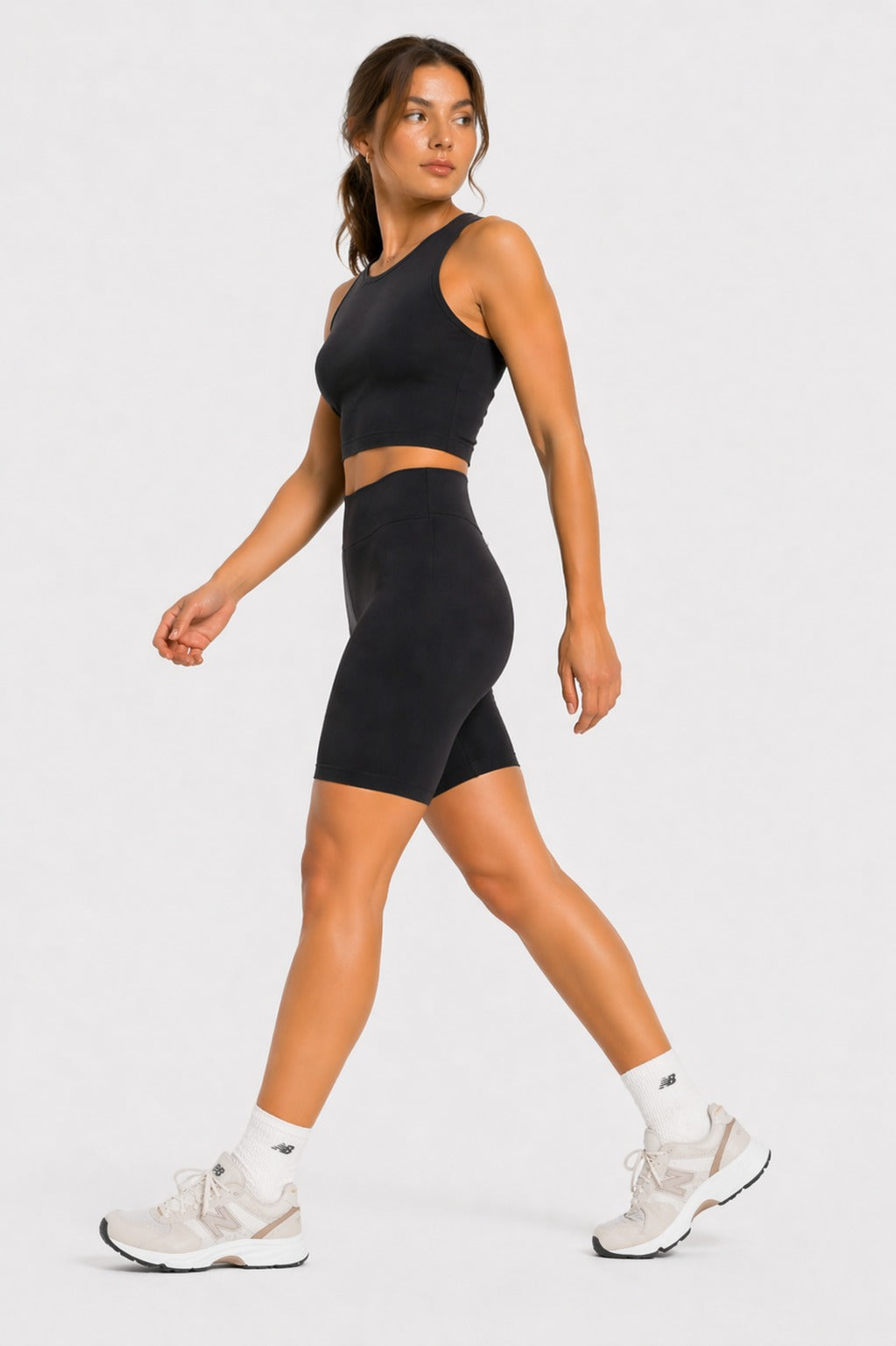Side view of black cycling shorts on model walking