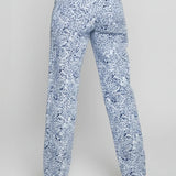 Blue floral pants worn by a person on a gray background