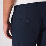 Close up of the back pocket on these navy blue chinos slim fit.