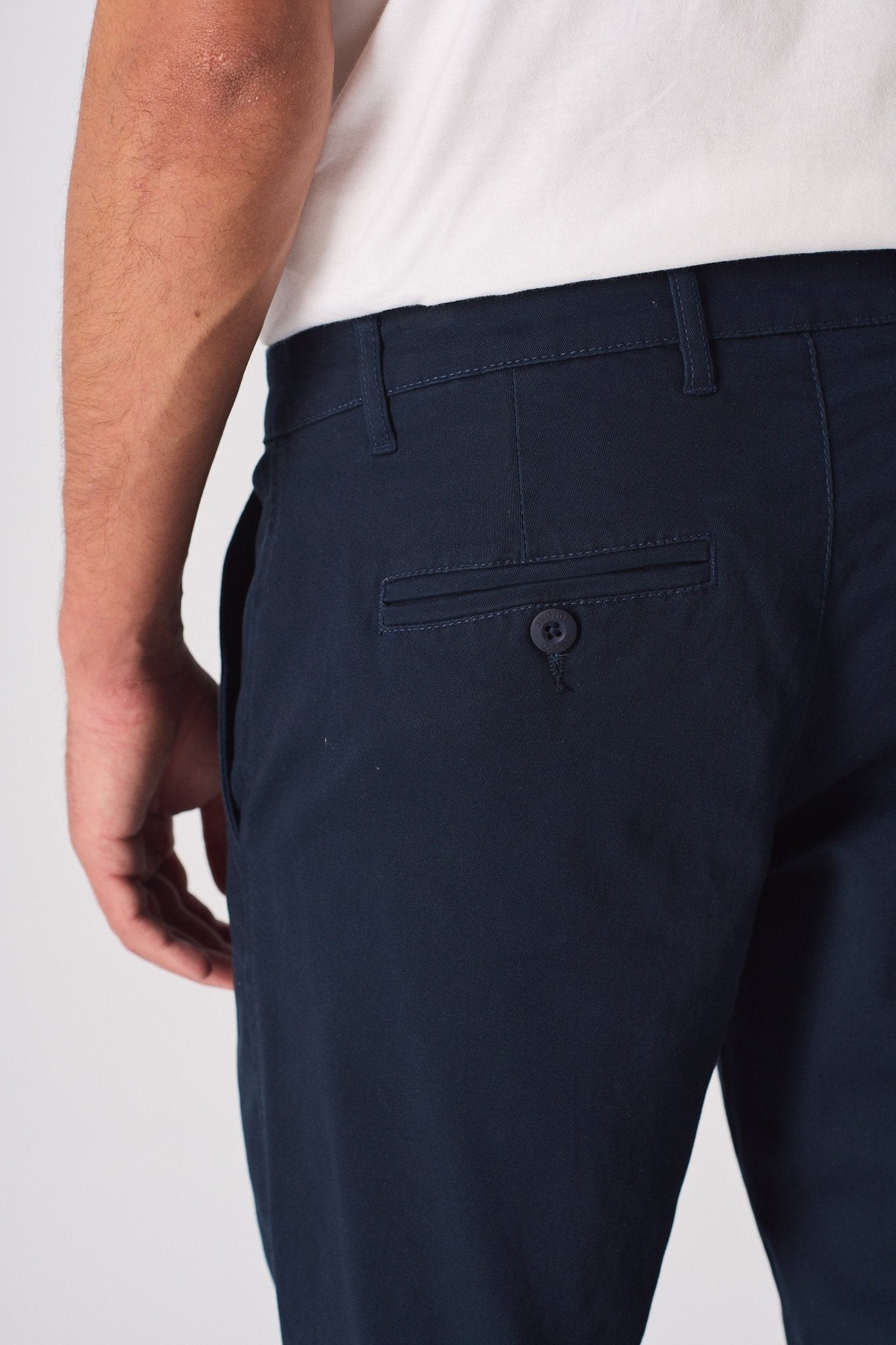 Close up of the back pocket on these navy blue chinos slim fit.