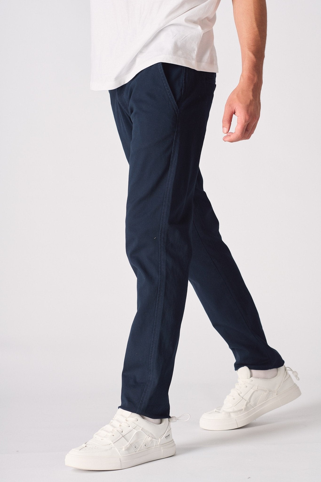 Side angle detail of the navy blue chinos slim fit showing the fabric.