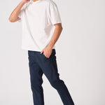 Side view of a male model wearing navy blue chinos slim fit.