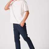 Side view of a male model wearing navy blue chinos slim fit.