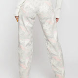 Full back view of a model wearing abstract swirl pattern high-rise jeans with classic back patch pockets.