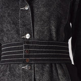 Detailed close-up of the white contrast stitching on the belt of the acid wash dress