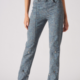 Person wearing acid-wash jeans on a plain background