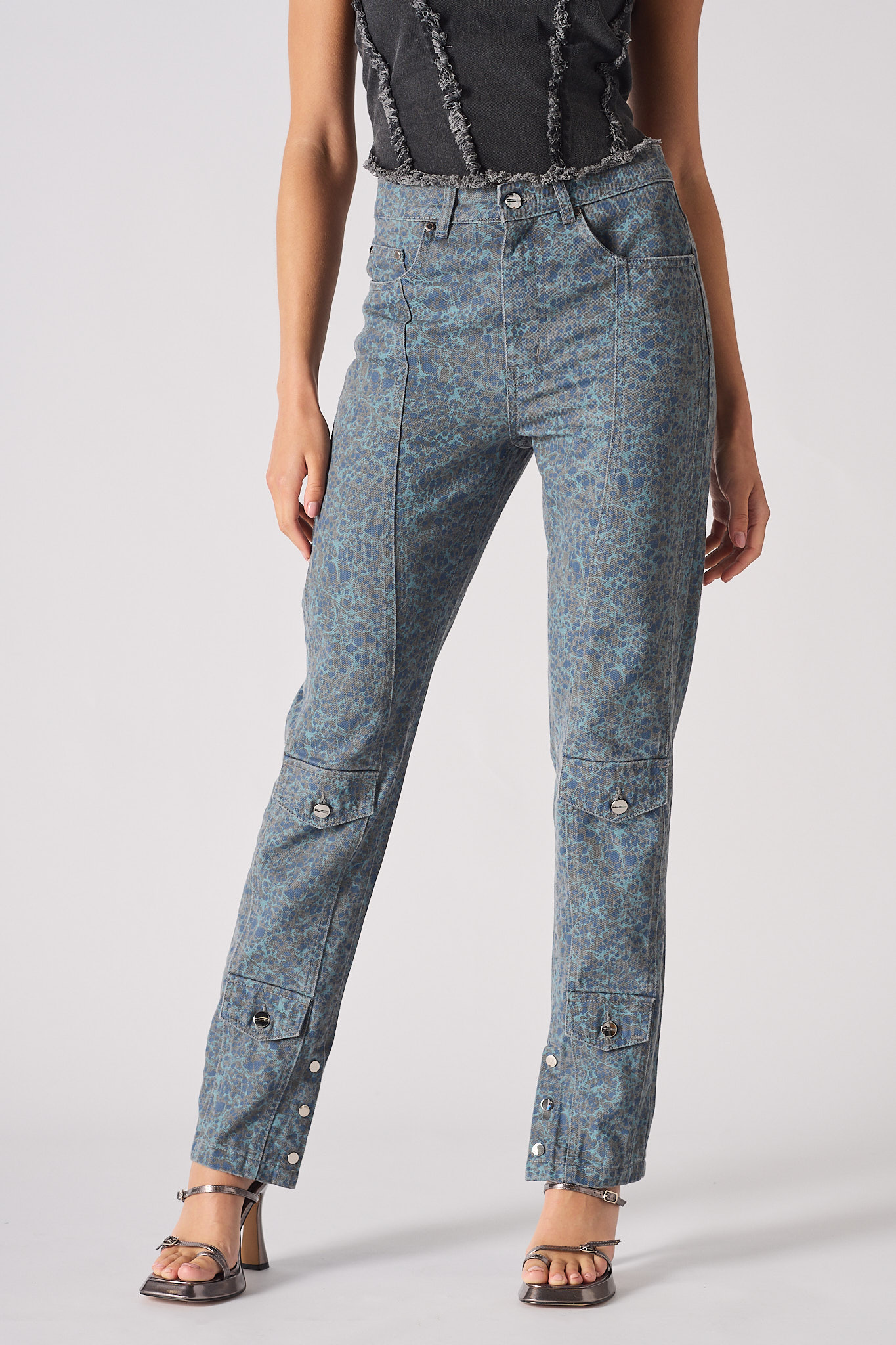 Person wearing acid-wash jeans on a plain background