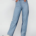 Front view of women's two-tone wide leg jeans featuring an asymmetrical crossover waistband