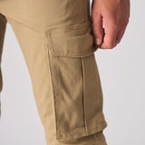 Detailed shot of the 3D cargo pocket on these beige cotton cargo pants.