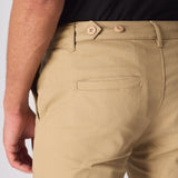 Close up of the back of the beige cotton cargo pants showing the adjustable waist strap.