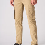 A man walking in beige cotton cargo pants to highlight the comfortable slim fit.