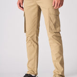 A man walking in beige cotton cargo pants to highlight the comfortable slim fit.