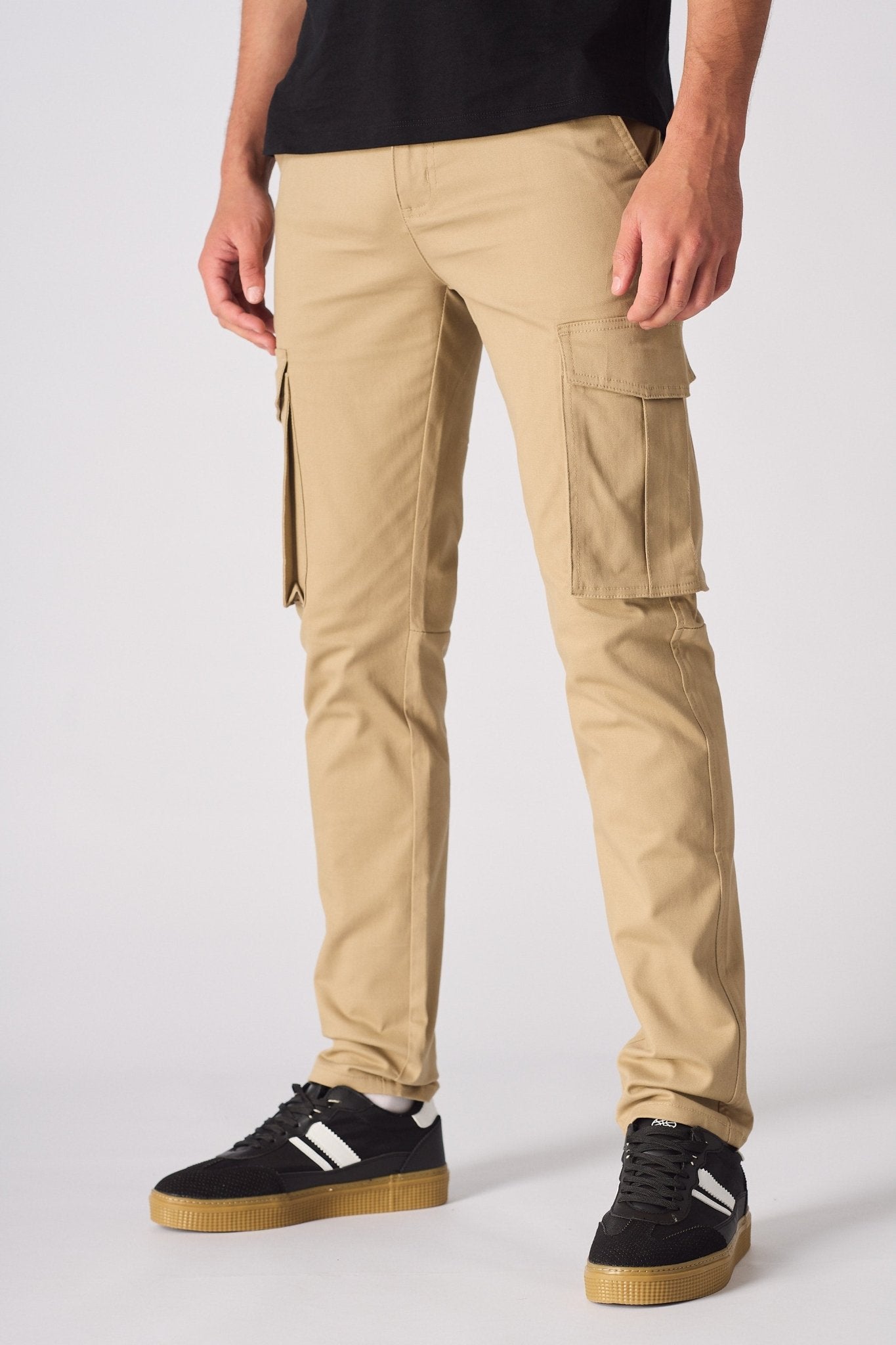 A man walking in beige cotton cargo pants to highlight the comfortable slim fit.