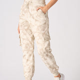 Side profile of women in beige tie dye cuffed cargo joggers
