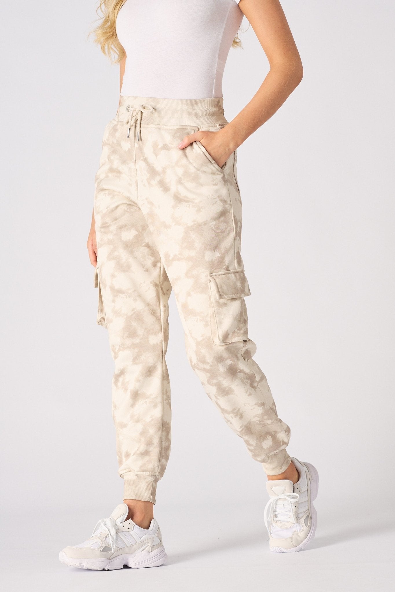 Side profile of women in beige tie dye cuffed cargo joggers