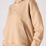 Front view of a beige hoodie for women with a comfortable oversized design