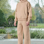 A model wearing beige joggers for men with a matching hoodie