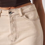 Close-up of beige pants with a blurred background