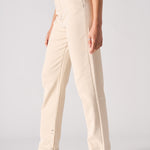 Beige pants worn by a person on a plain background