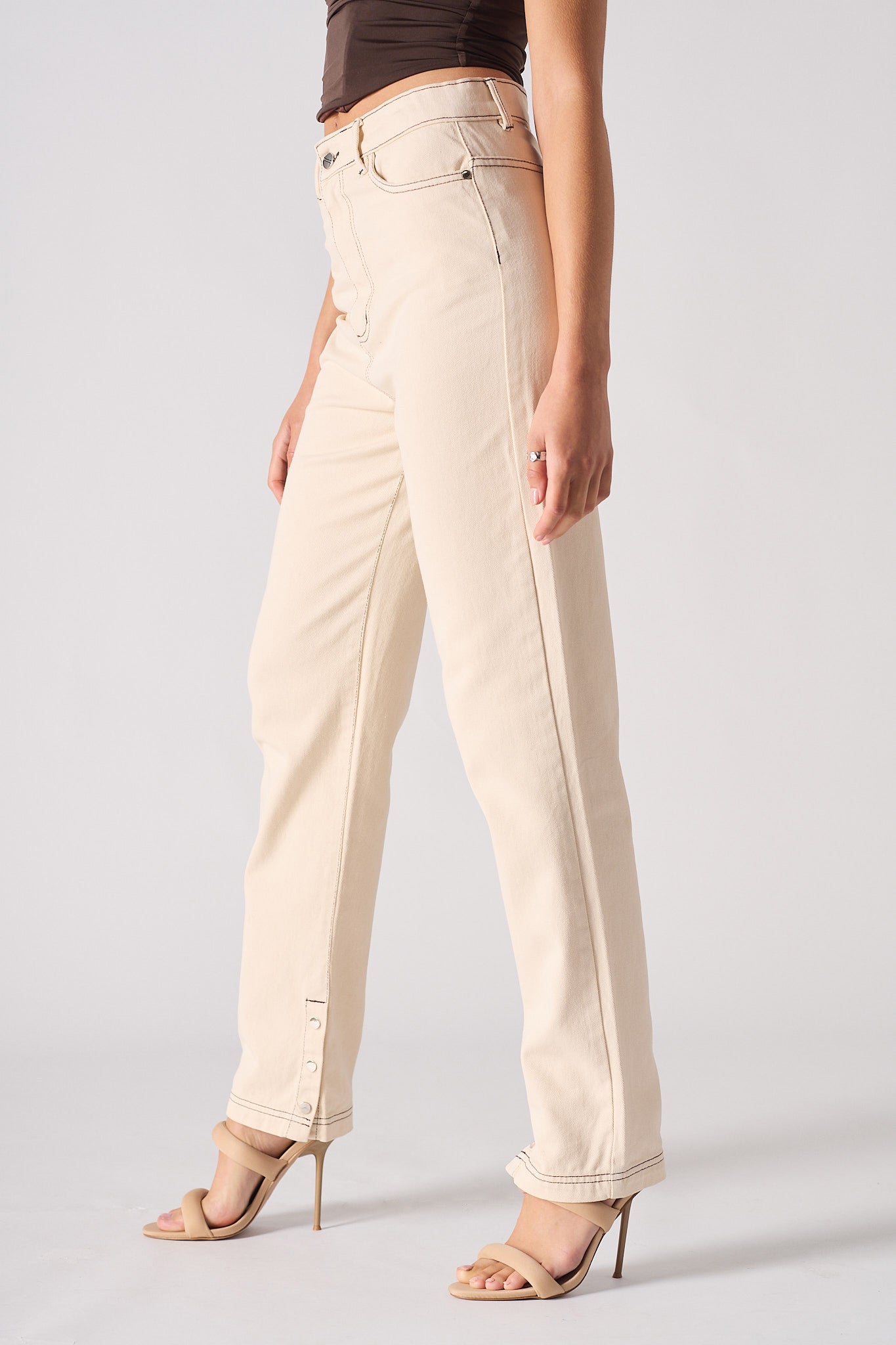 Beige pants worn by a person on a plain background