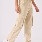 Side angle of a model posing in the premium beige straight leg cargo pants.
