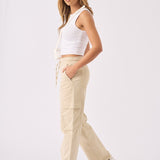 Side profile of a model walking in comfortable beige straight leg cargo pants.
