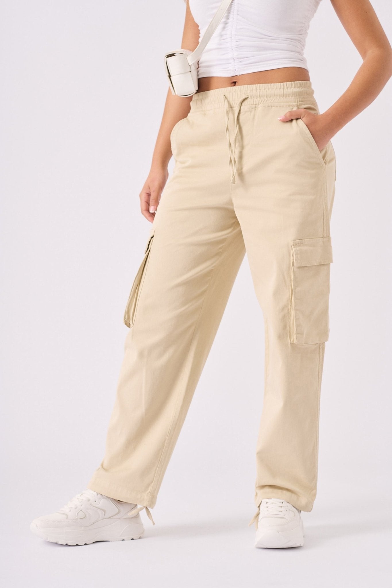 Full body shot of a model wearing Jmojo beige straight leg cargo pants.