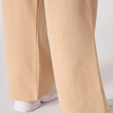 A detail shot of the wide leg opening and hem on the beige joggers