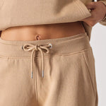 Close up of the comfortable waistband and drawstring on the beige joggers