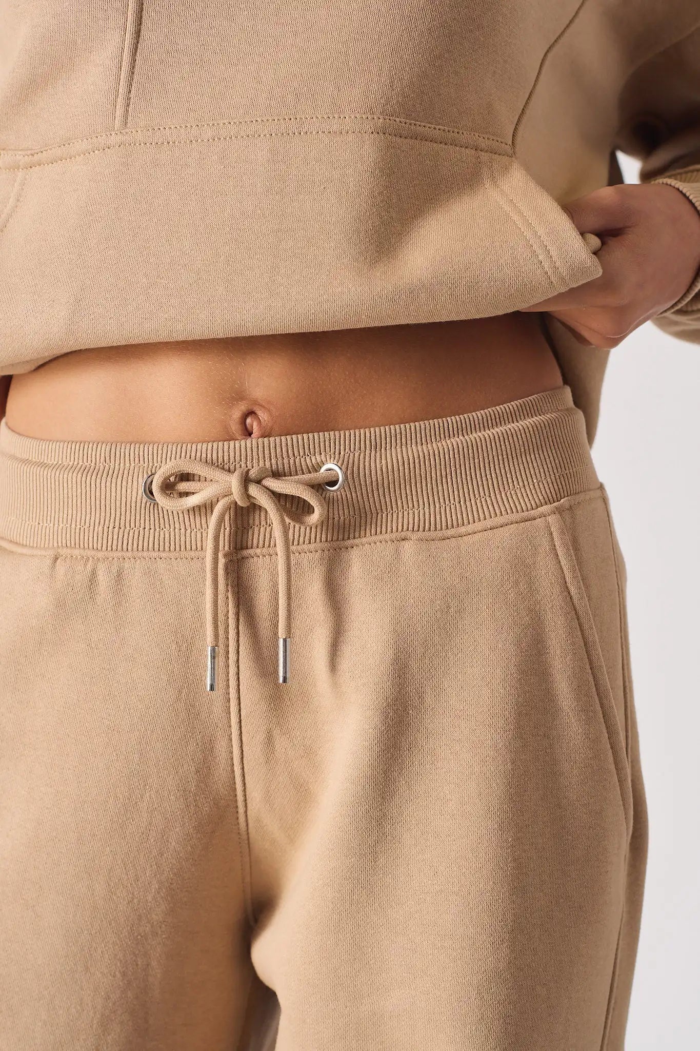 Close up of the comfortable waistband and drawstring on the beige joggers
