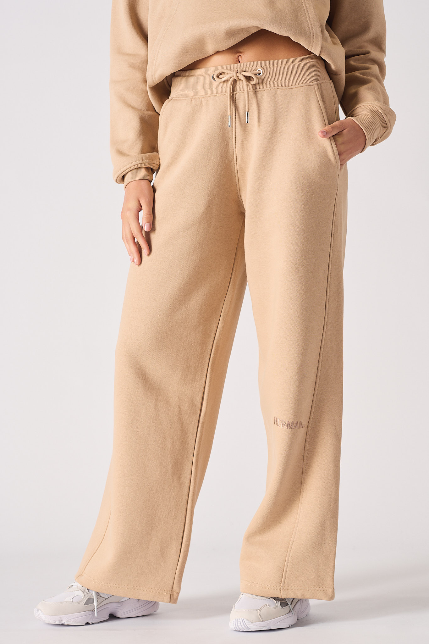Close up front view of the relaxed fit of these beige wide leg joggers