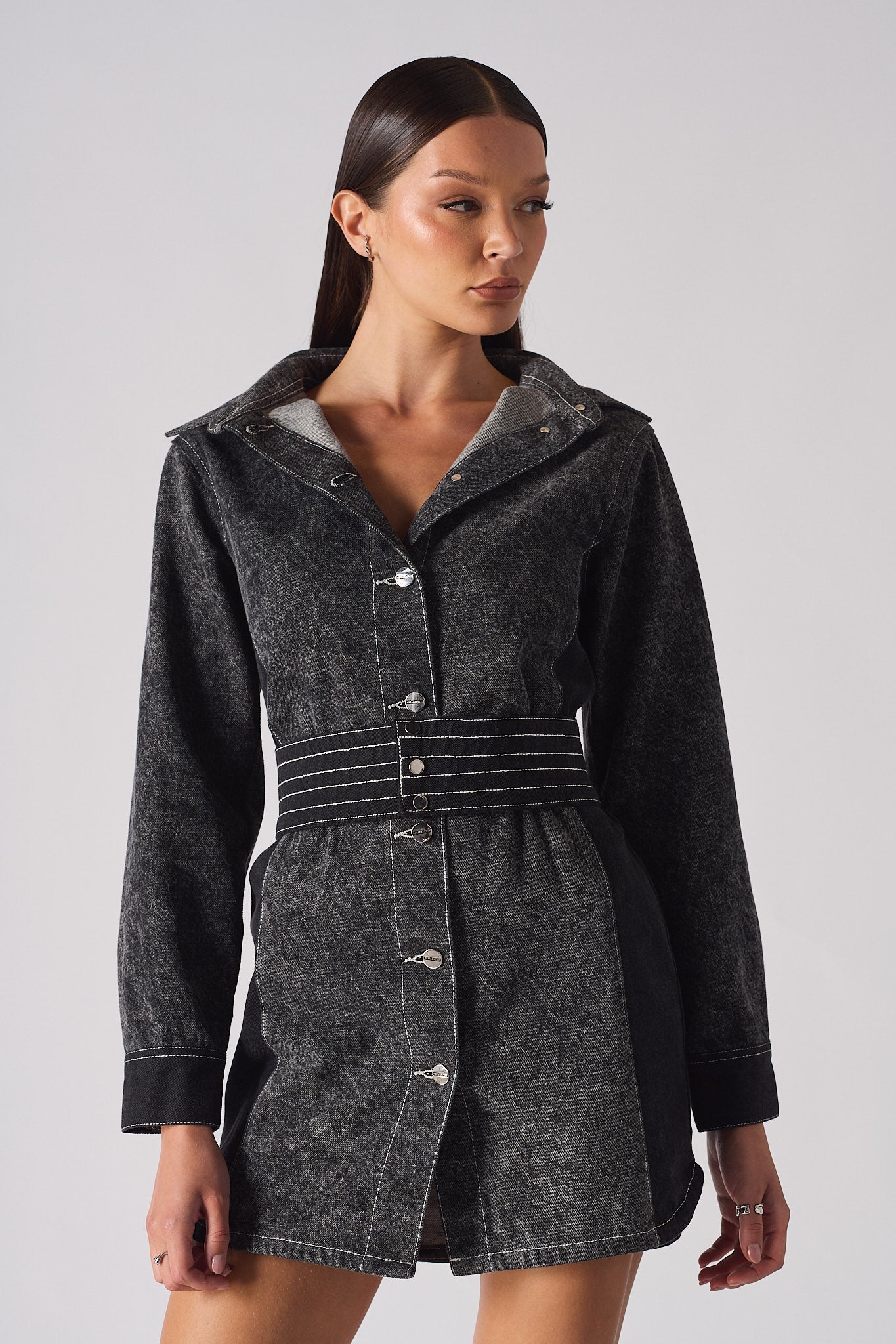 Close-up of the belted acid wash denim dress, focusing on the stitched belt and buttons