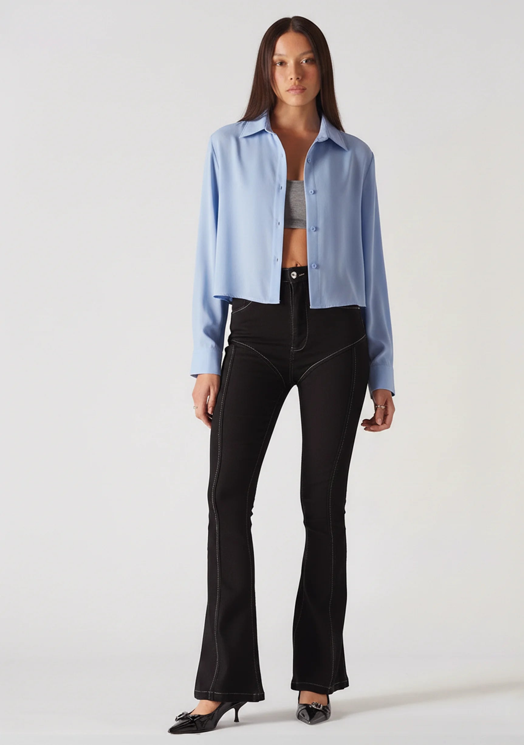 Side profile view of women's black bootcut jeans highlighting the form-fitting shape