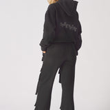 Back view showing the straight leg fit of the black cargo trousers.