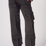 A woman wearing black cargo trousers womens straight leg in a front view shot.