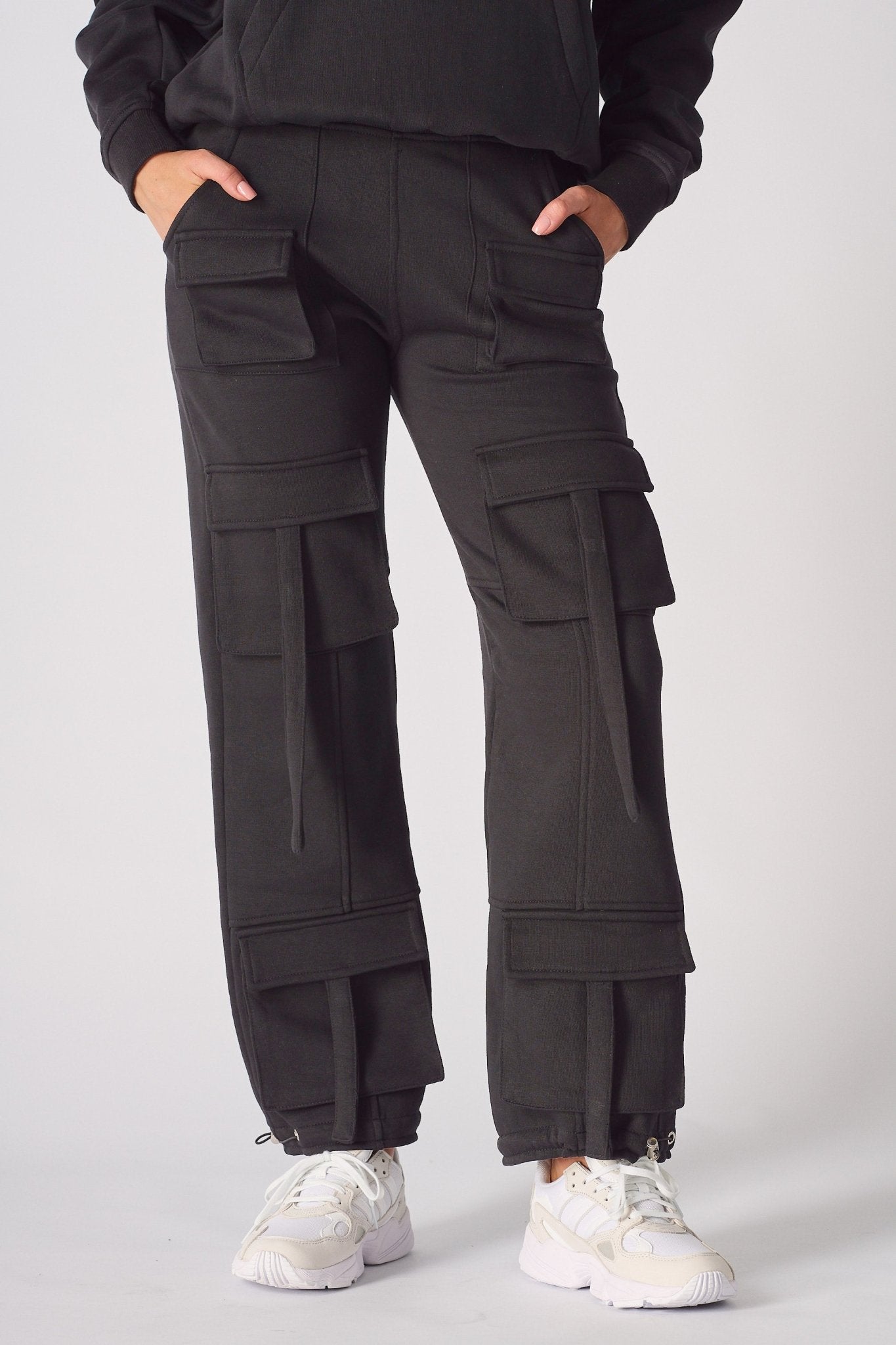 A woman wearing black cargo trousers womens straight leg in a front view shot.