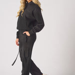 Side view of a woman walking in black cargo trousers womens straight leg.