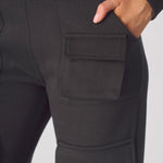 Close up of the back pocket on these black cargo trousers womens straight leg.