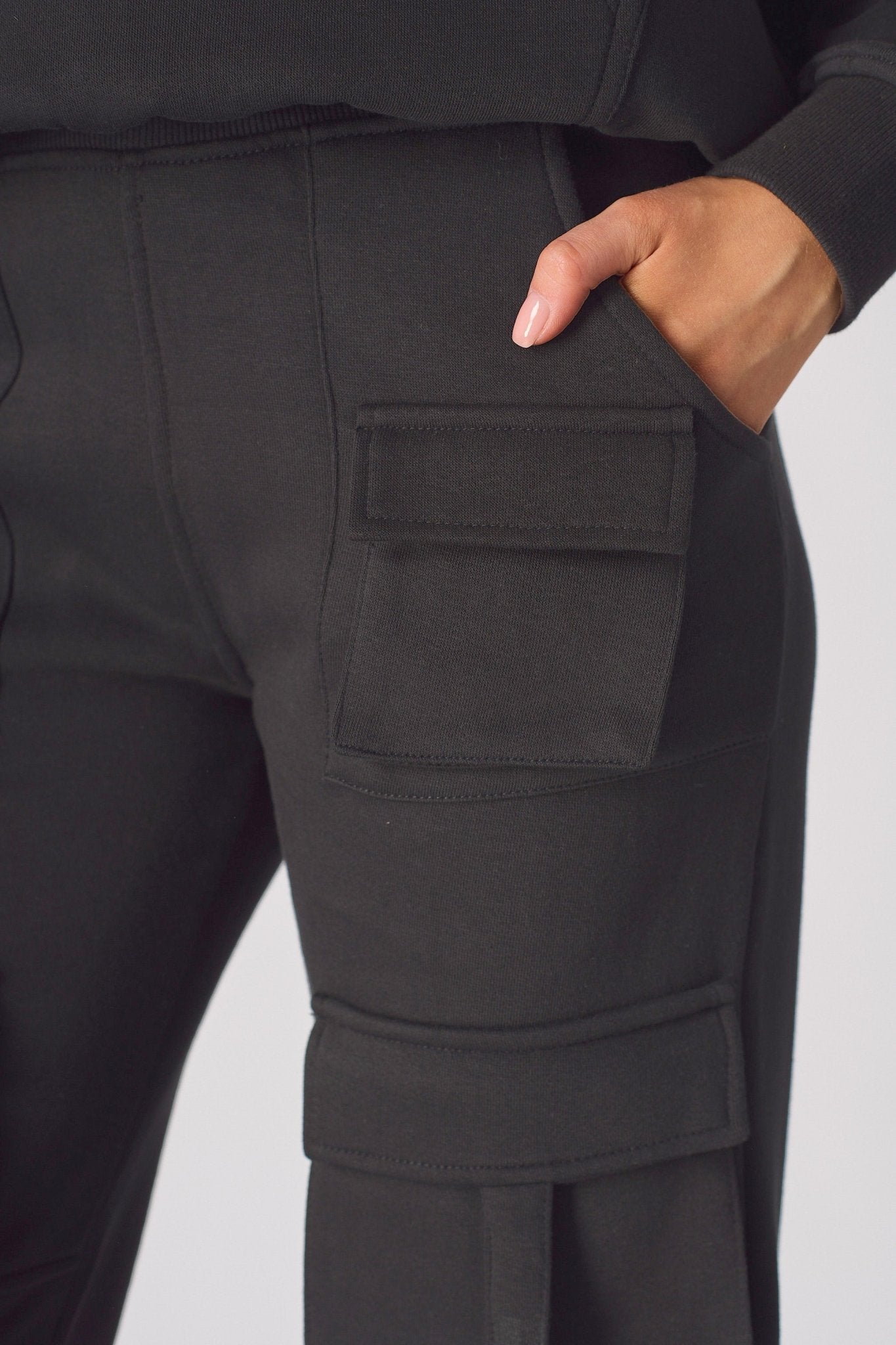 Close up of the back pocket on these black cargo trousers womens straight leg.