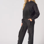 Side profile view of a model in black cargo trousers womens straight leg.