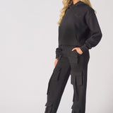 Side profile view of a model in black cargo trousers womens straight leg.