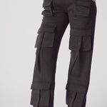 Close up of the multiple cargo pockets on black cargo trousers womens straight leg.