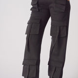 Close up of the multiple cargo pockets on black cargo trousers womens straight leg.