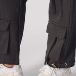 Detailed view of the comfortable drawstring waist on black cargo trousers.