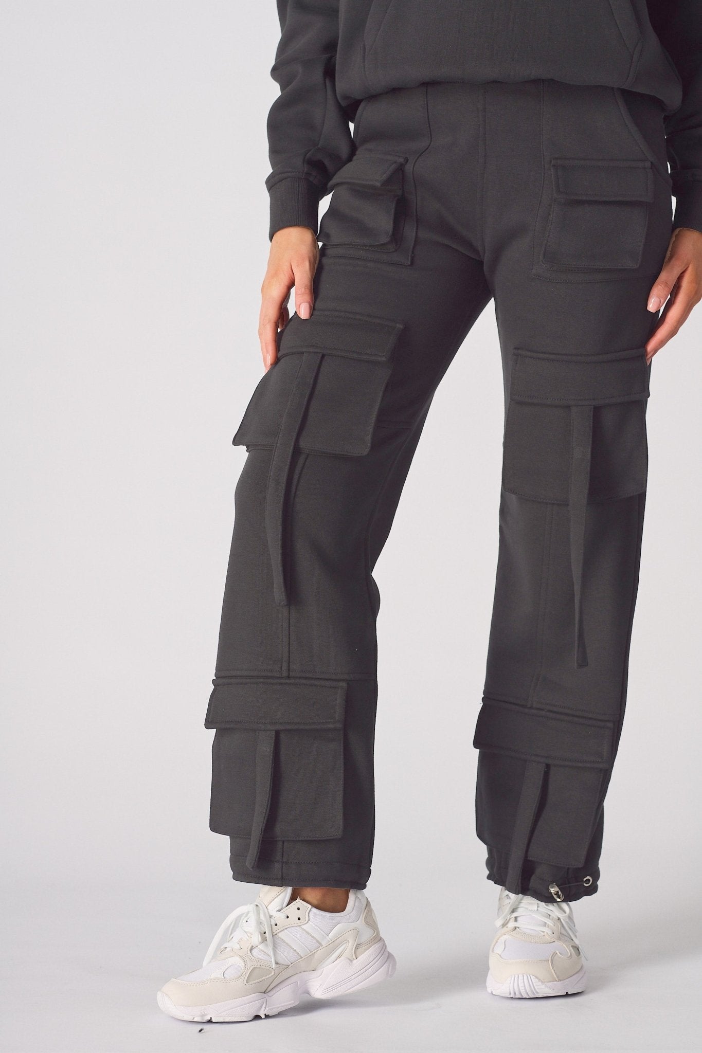 A model walking in comfortable black cargo trousers womens straight leg.