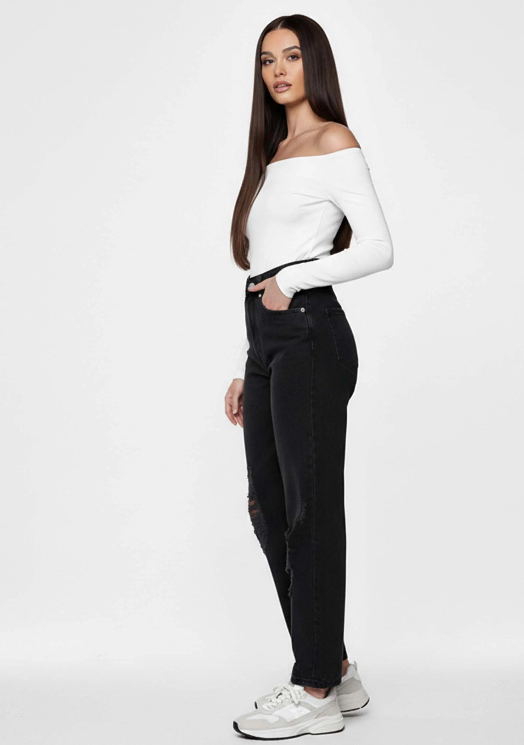 Side profile view of a model wearing Black Denim Straight Leg Women's Jeans