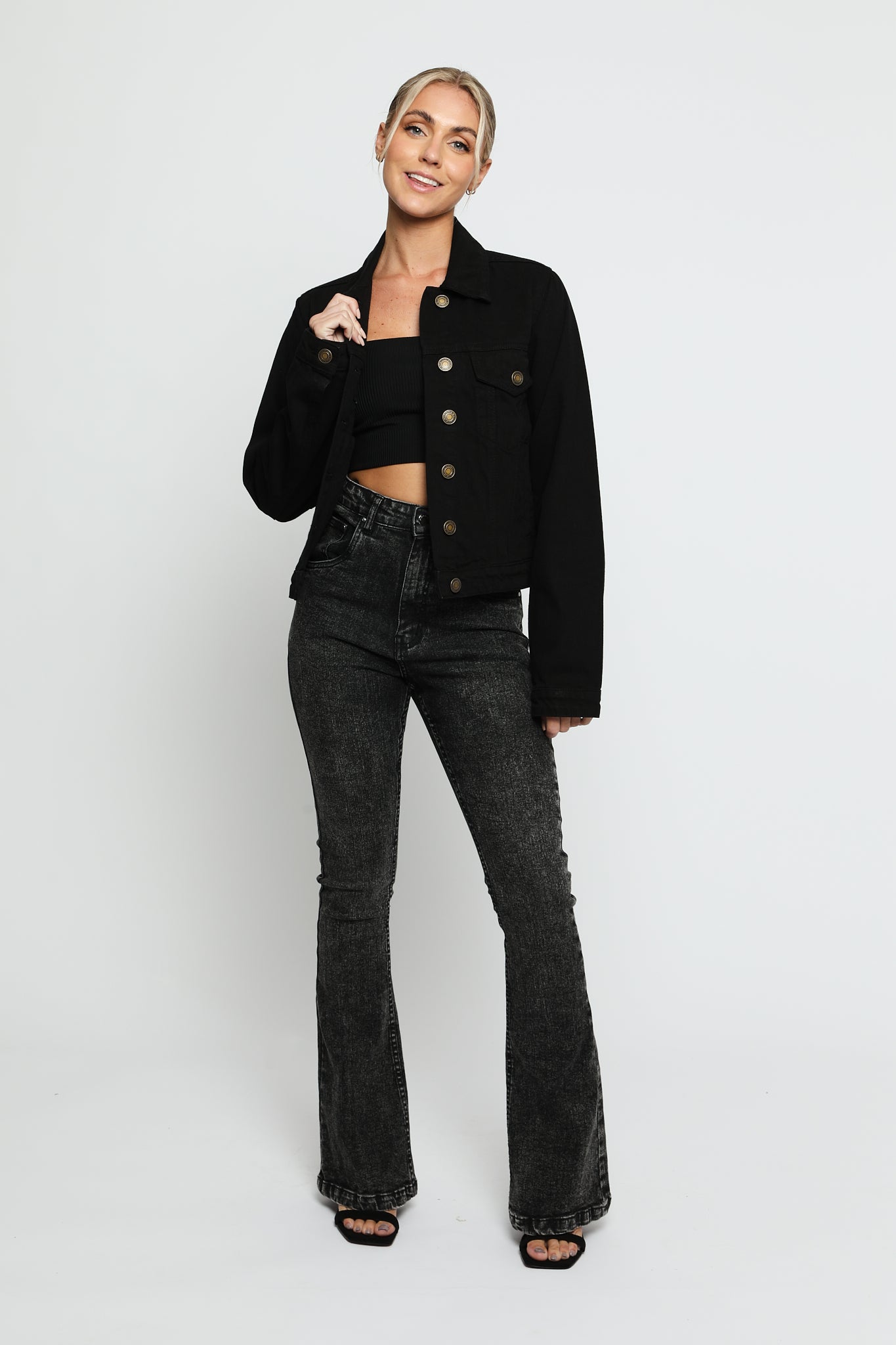 Full front view of women's black denim trucker jacket with button front closure - regular fit cotton jean jacket
