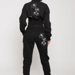 Full back view of the black joggers and hoodie set with matching floral embroidery