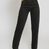 Person wearing black high-waisted jeans on a white background